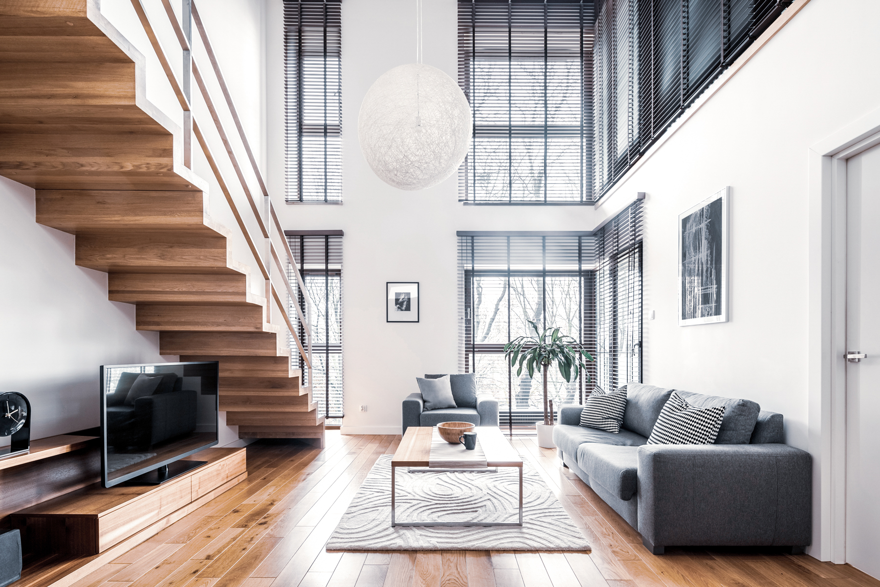 A double-height living room with a timber stair