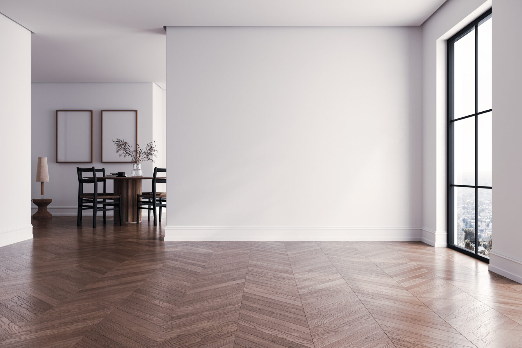 An empty room with herringbone floor and tall windows
